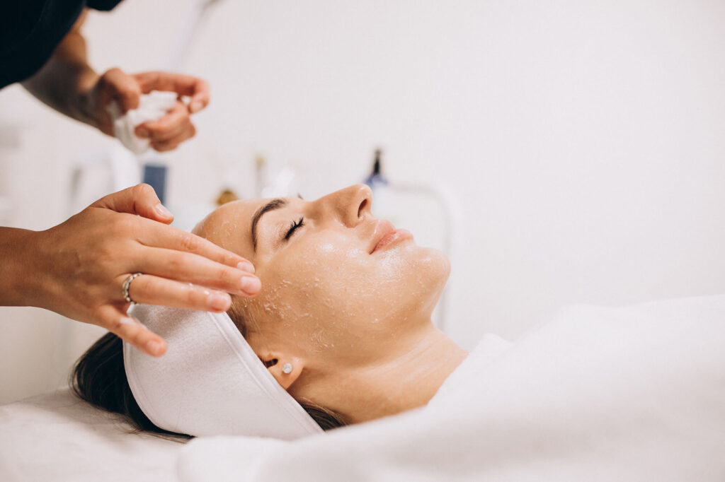 Woman receiving a professional chemical peel to improve skin texture and tone at Skin Luxe Medical Aesthetics in Salado