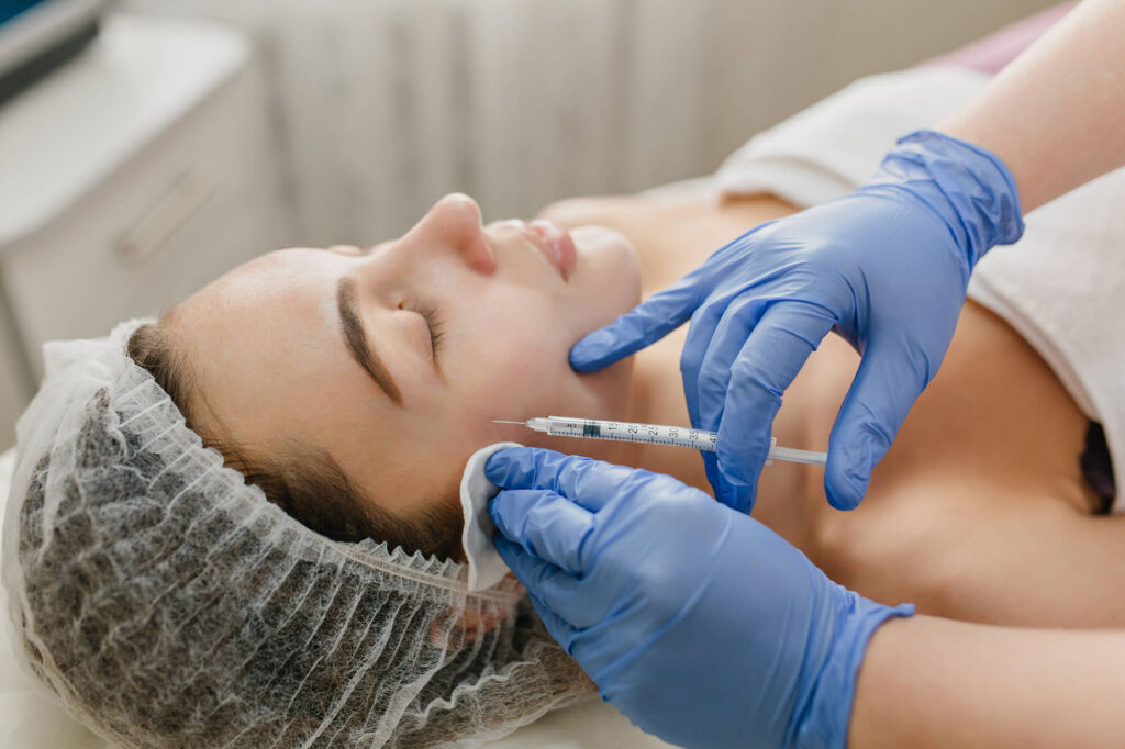 Professional applying Daxxify injectable for smoother skin