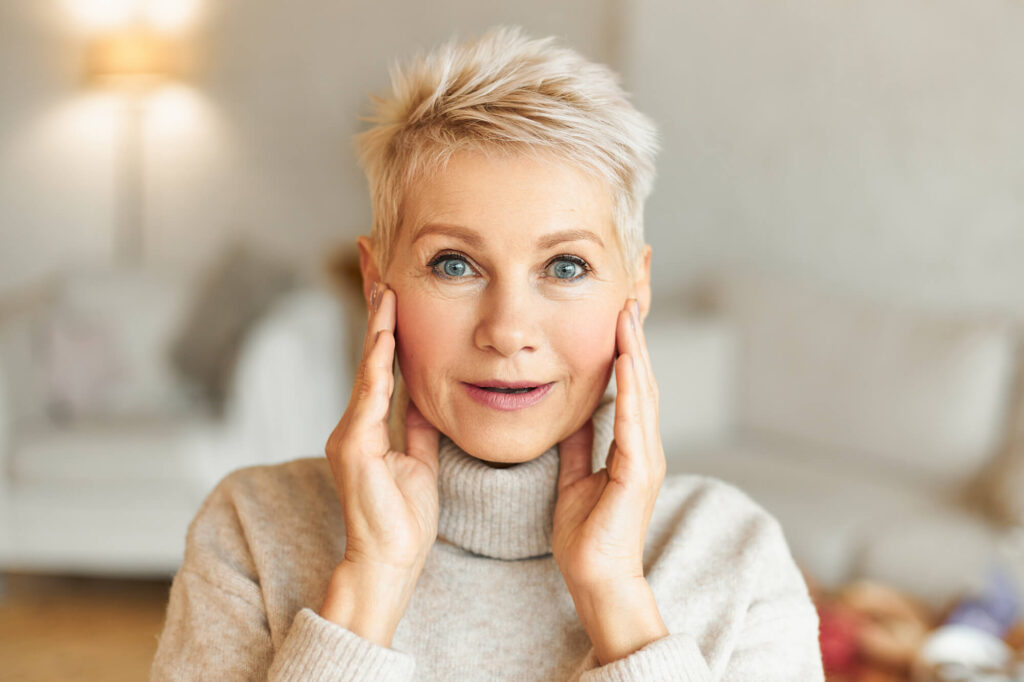 Smiling client with youthful skin after Sculptra treatment