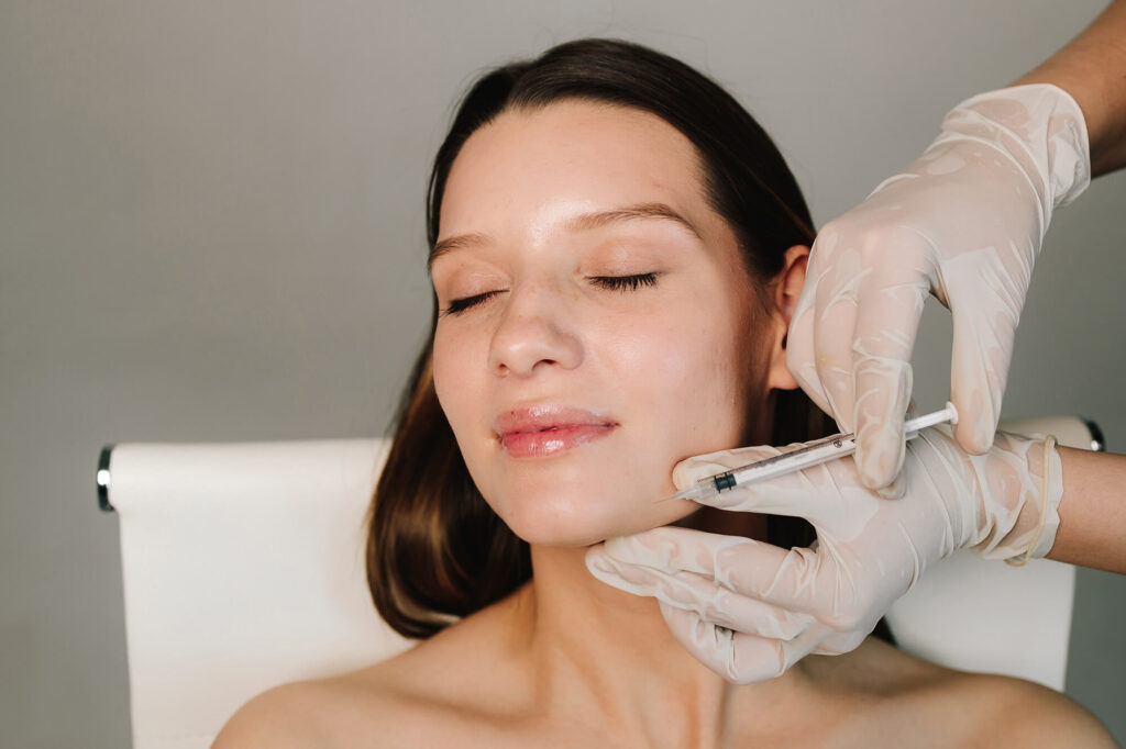 Aesthetic provider injecting Radiesse for natural collagen boost