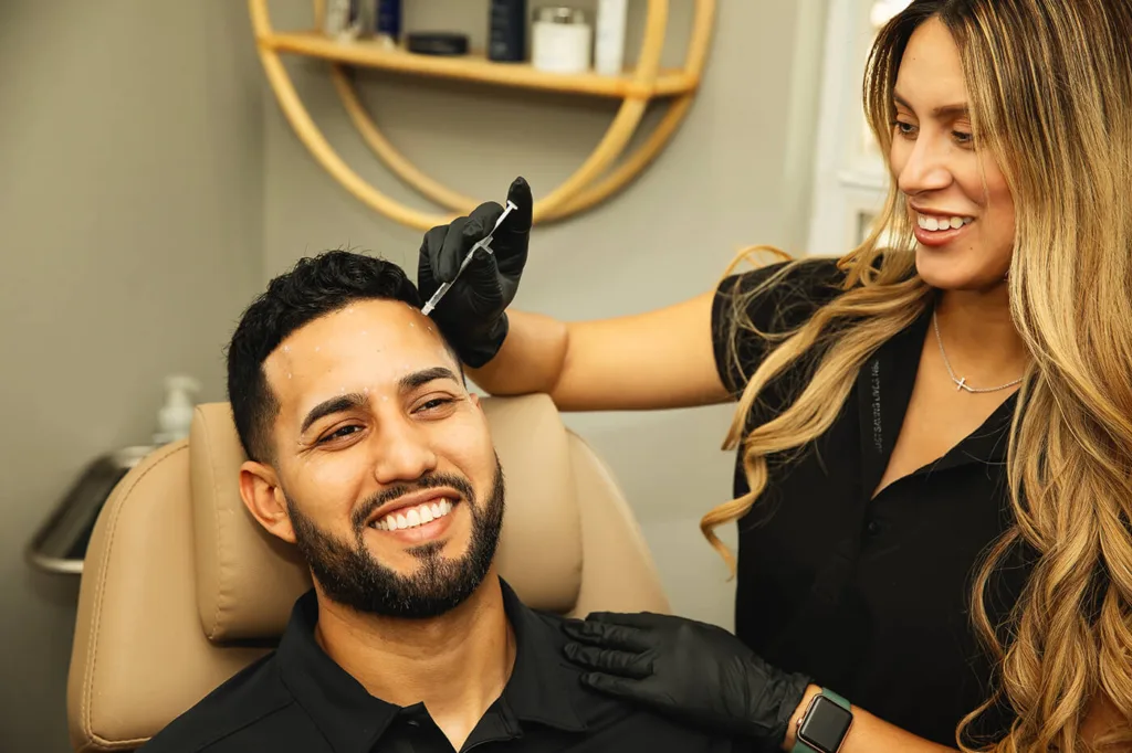 Young man during skin rejuvenation procedure at Skin Luxe Medical Aesthetics 